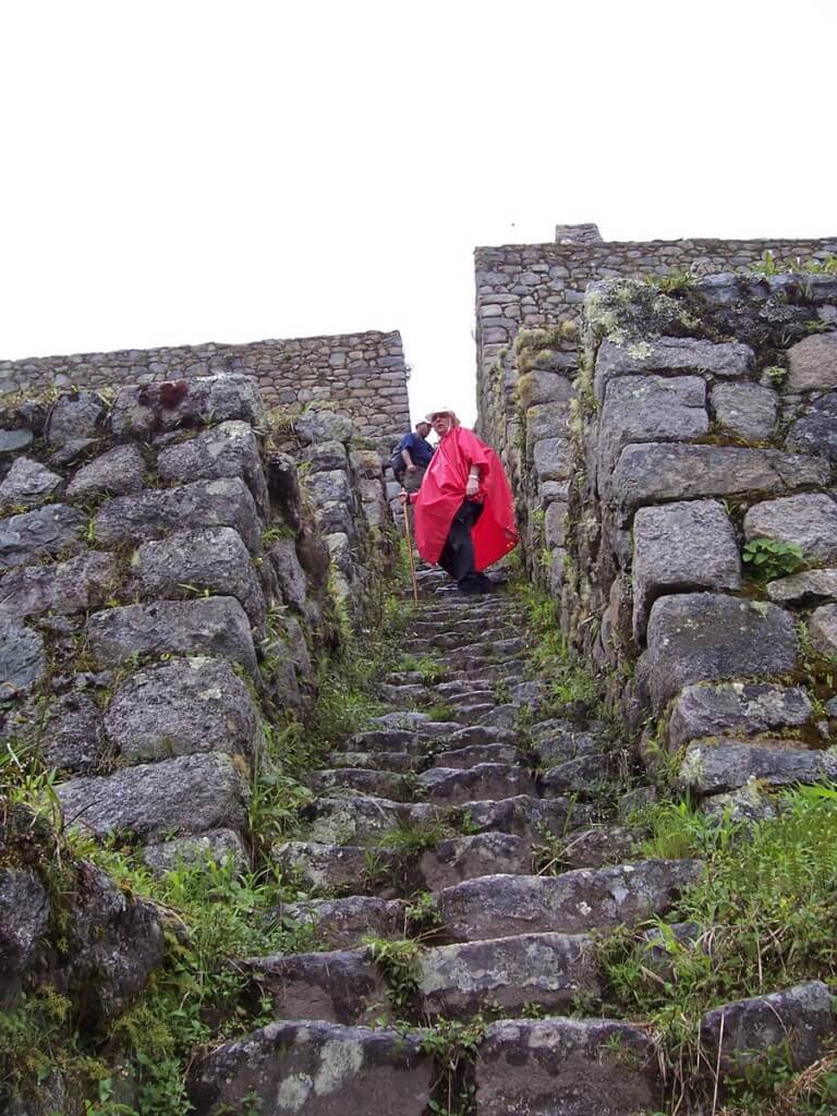 Bob climbs the stone steps at the Wiñay Wayna ruins on the Inca Trail in Peru, South America