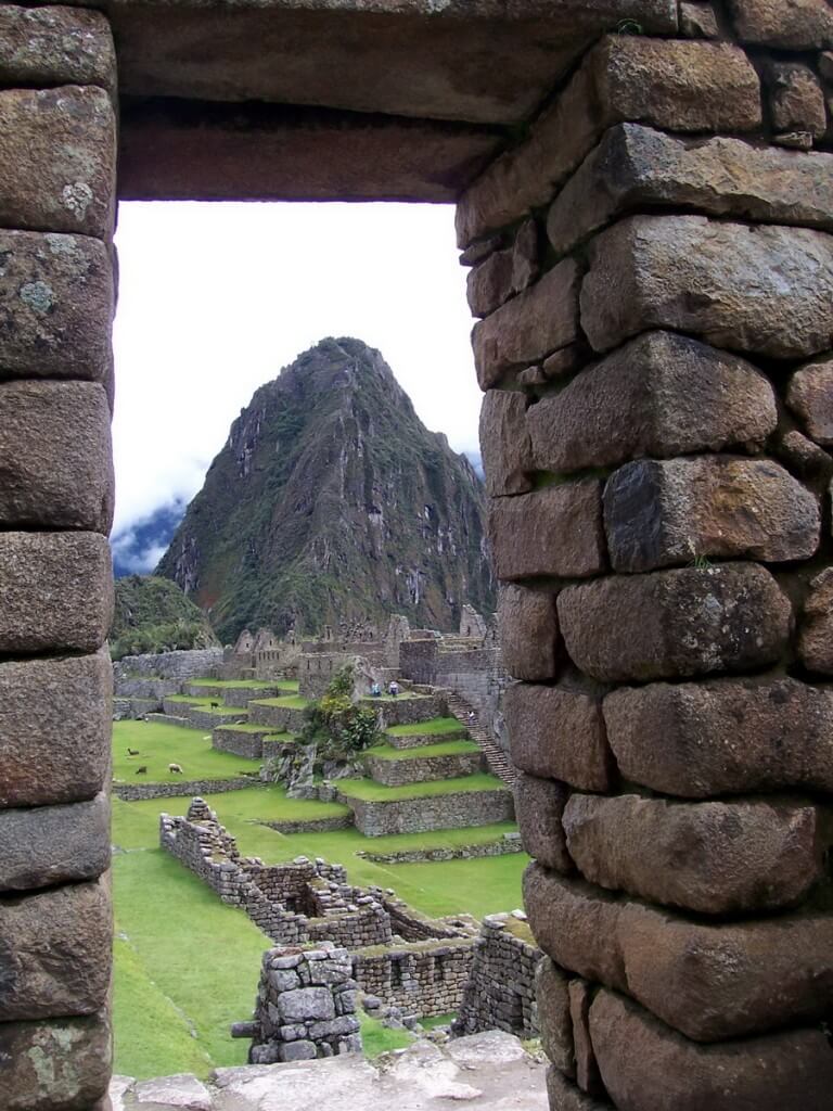 An image of Machu Picchu through the main stone gate in Urubamba Province, Peru.