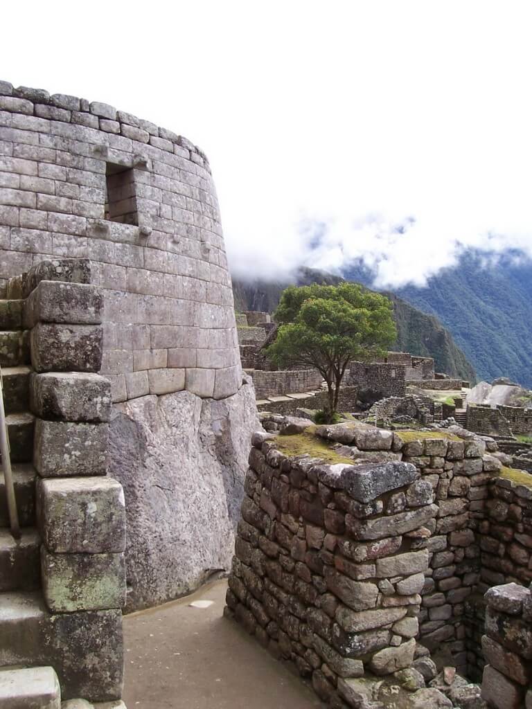 An image of the stone wall of the Tower of the Sun at Machu Picchu in Urubamba Province, Peru.