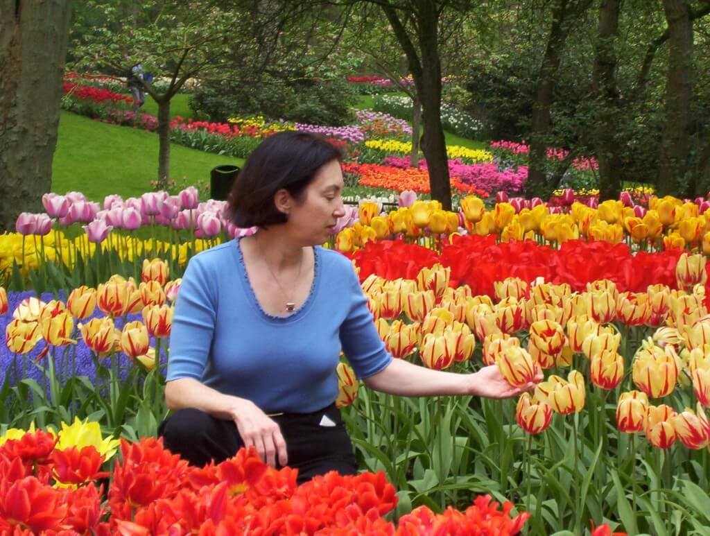 An image of Jean among tulips at Keukenhof Gardens near Lisse, in the Netherlands. Photography by Frame To Frame - Bob and Jean. 