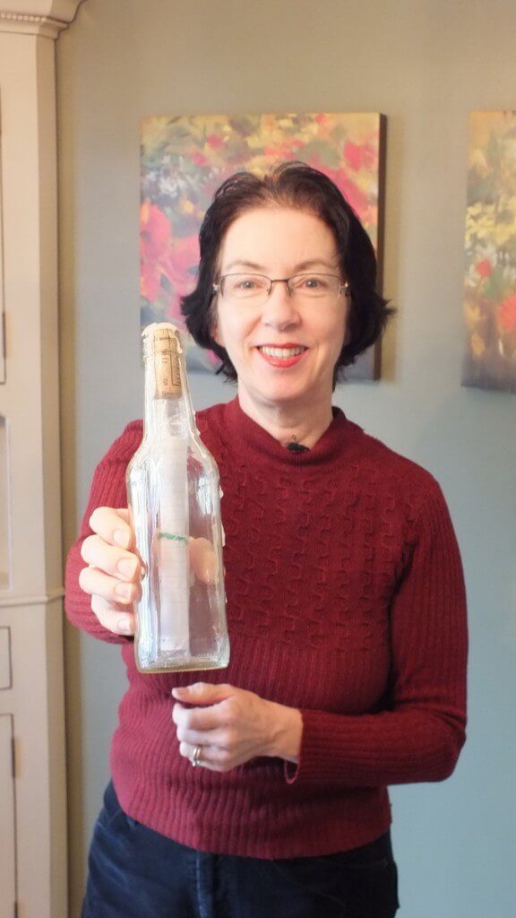 Jean holds the Message in a Bottle