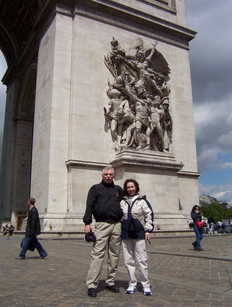 An image of Bob and Jean standing in front of the Arc de Triomphe in Paris, France.