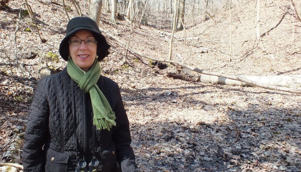 Jean stands beside Skunk Cabbage plants in Hamilton - Ontario