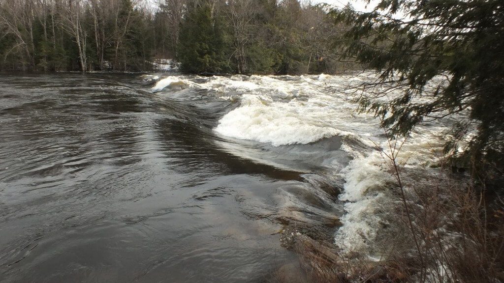 Oxtongue Lake control dam - waters high above dam during major flooding - April 20 2013