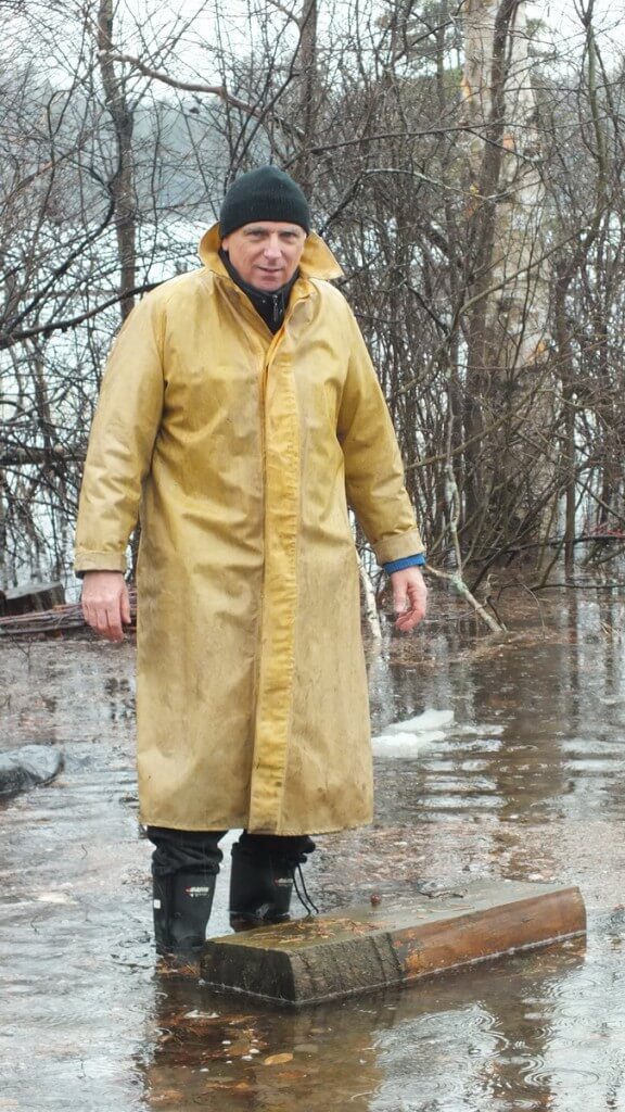 Oxtongue Lake flooding - Bob prepares to move block of wood from flood waters - April 20 2013