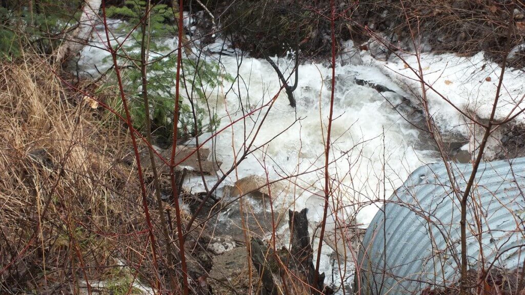 Oxtongue Lake flooding - fast moving water from distant hills - April 20 2013