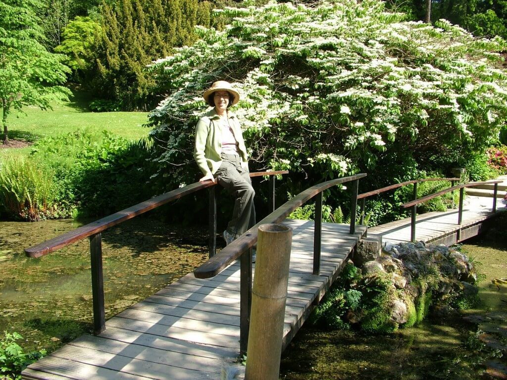 jean sits on bridge in japanese gardens - powerscourt - ireland