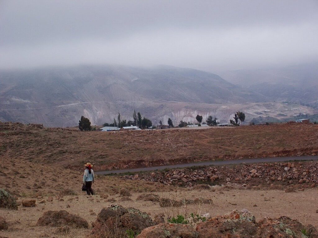 Young girl walks across the countryside near Nazca, Peru