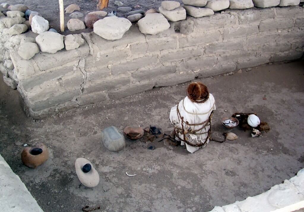 Human mummified body and skulls at the Chauchilla Cemetery in Peru, South America