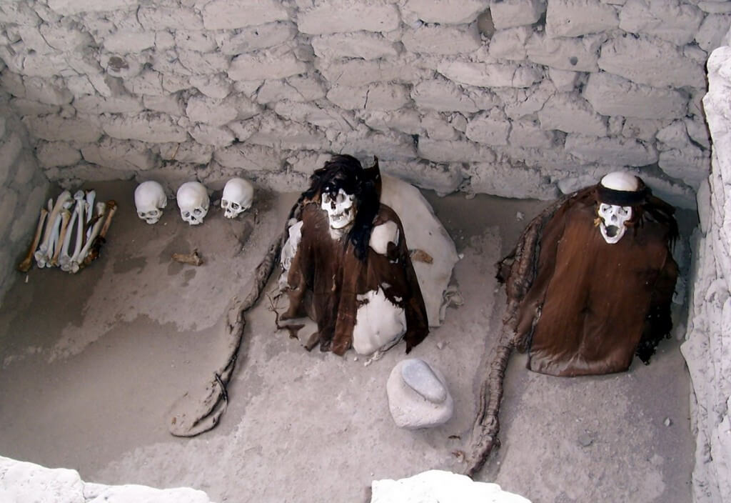 Human skulls and bones in an open gravesite at the Chauhilla Cemetery near Nazca in Peru, South America.