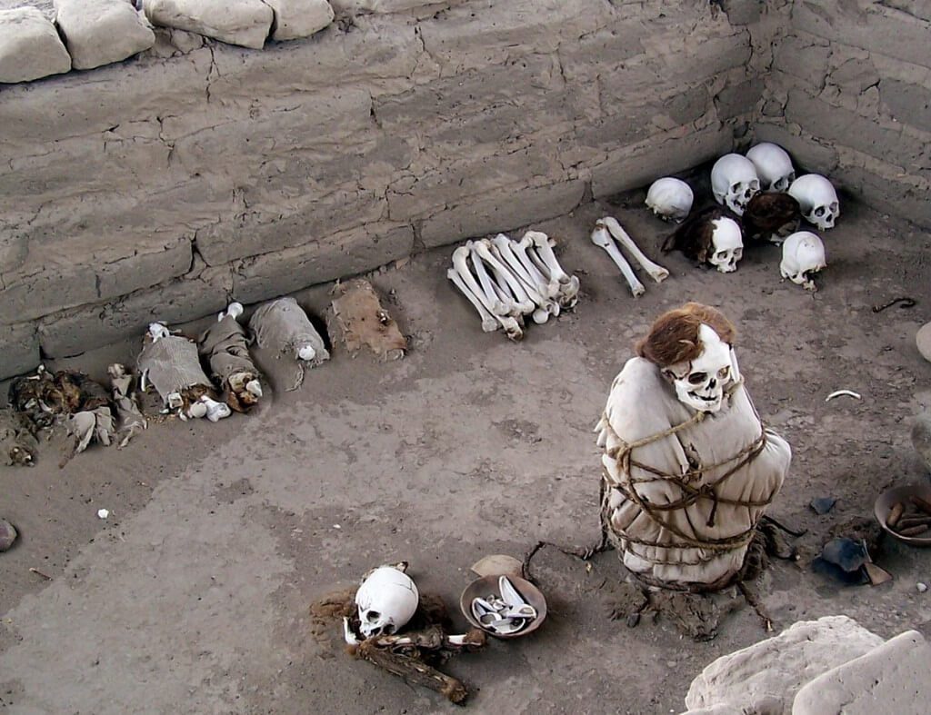 Human Mummified body and skulls and bones at the Chauchilla Cemetery in Peru, South America