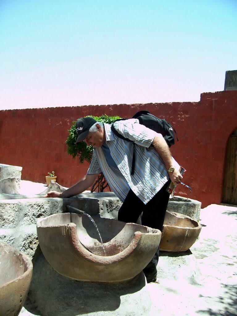 Bob checks out water flow, Santa Catalina Convent, Arequipa, Peru