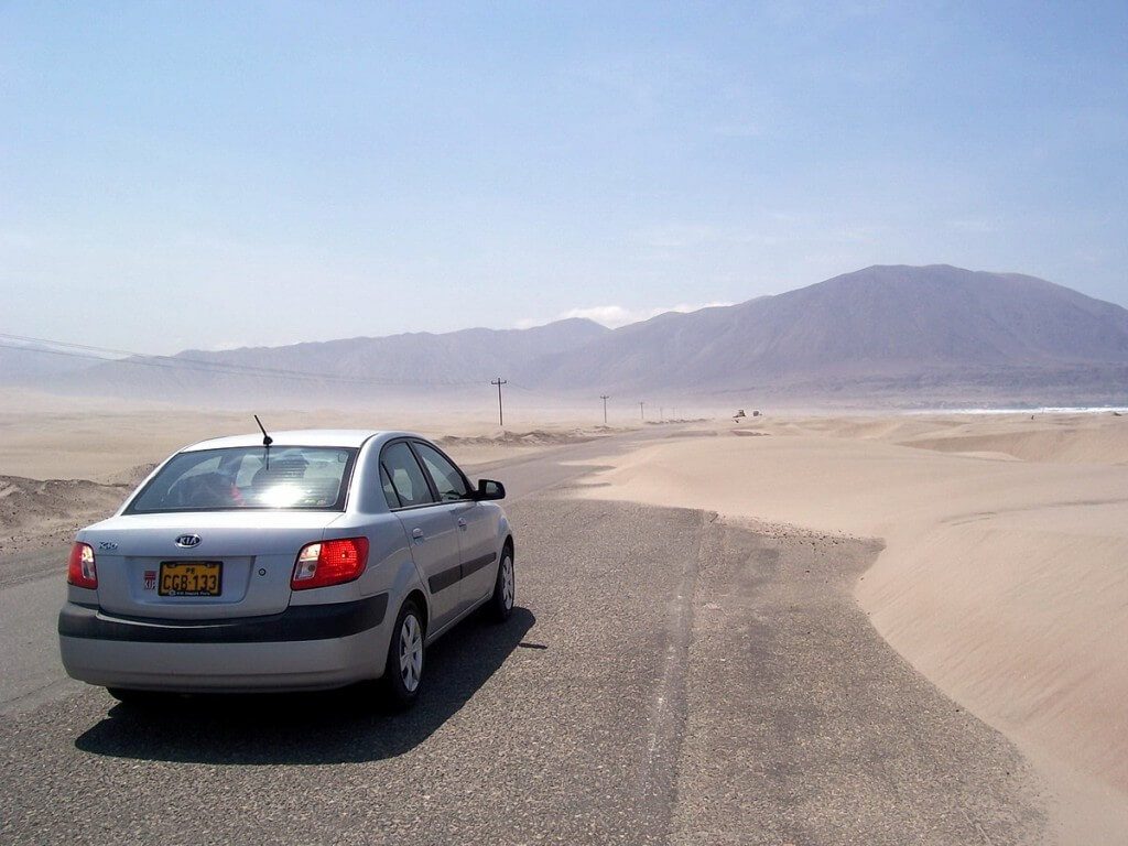 Sanddunes partially block pan american highway - peru - frame to frame