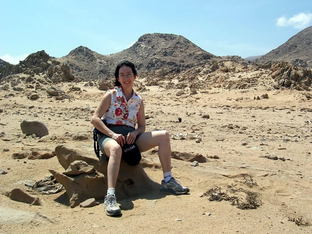 jean sits on rock in nazca desert in peru - frame to frame