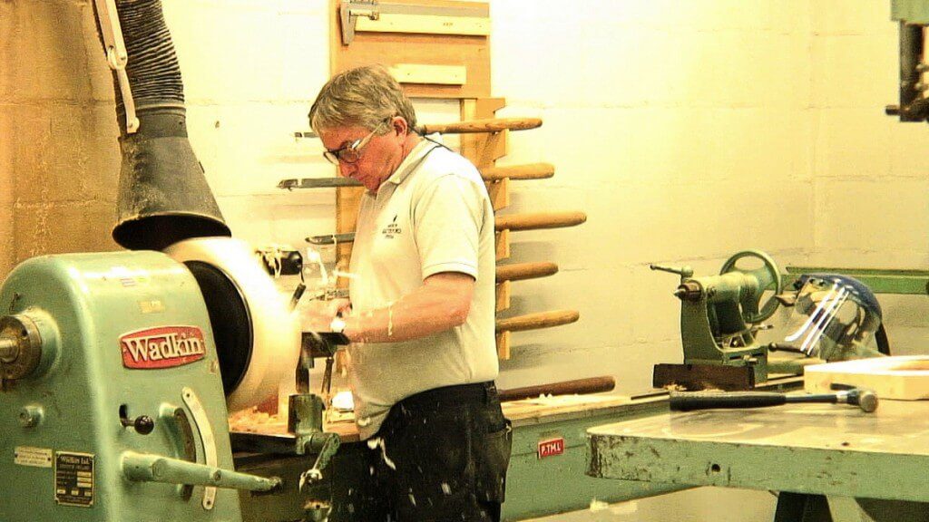 Image of a man carving a wooden mold at the Waterford Crystal plant in Waterford, Ireland. Photography by Frame To Frame - Bob and Jean.