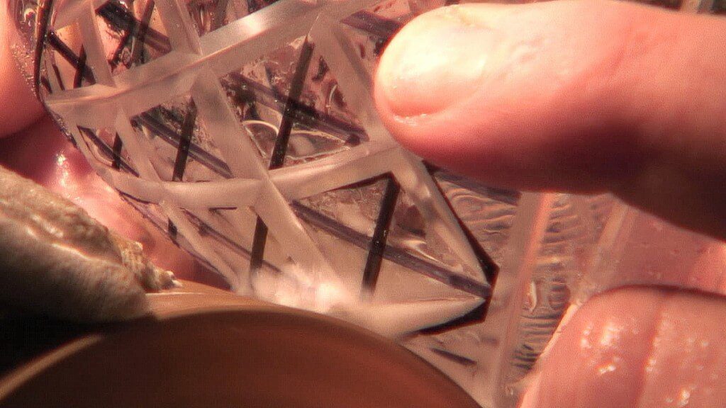 A closeup image of a crystal goblet being cut at the Waterford Crystal factory in Waterford, Ireland. Photography by Frame To Frame - Bob and Jean.