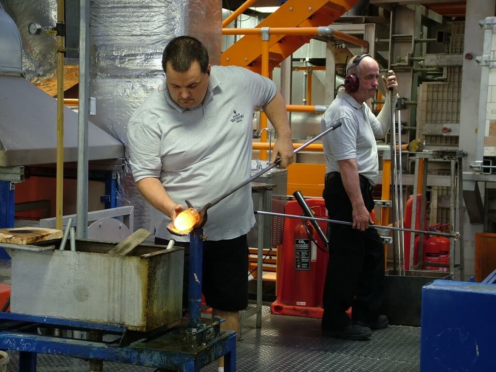  An image of a glass blower working with molten glass at the Waterford Crystal factory in Waterford, Ireland. Photography by Frame To Frame - Bob and Jean.