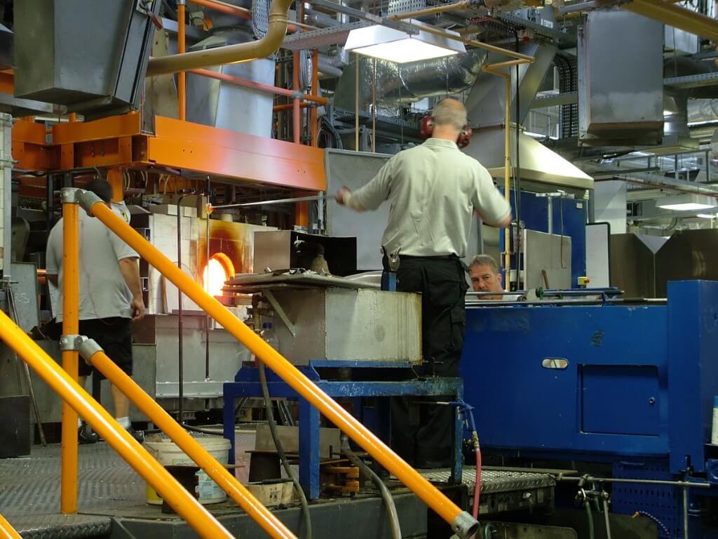 An image of glass blowers heating glass in the furnace at the Waterford Crystal factory in Waterford, Ireland. Photography by Frame To Frame - Bob and Jean.