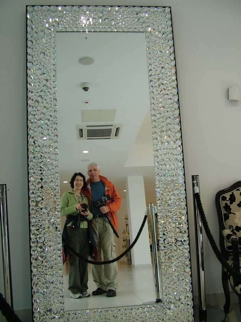 An image of Jean and Bob reflected in a large mirror at House of Waterford Crystal in Waterford, Ireland. Photography by Frame To Frame - Bob and Jean.