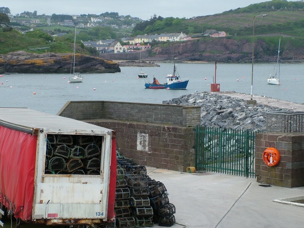 an image of lobster traps sitting on main wharf at dunmore east in county waterford - ireland