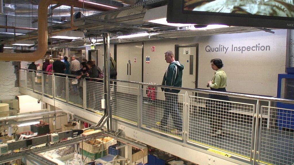 Image of tour group above the quality control room at the Waterford Crystal factory in Waterford, Ireland. Photography by Frame To Frame - Bob and Jean.