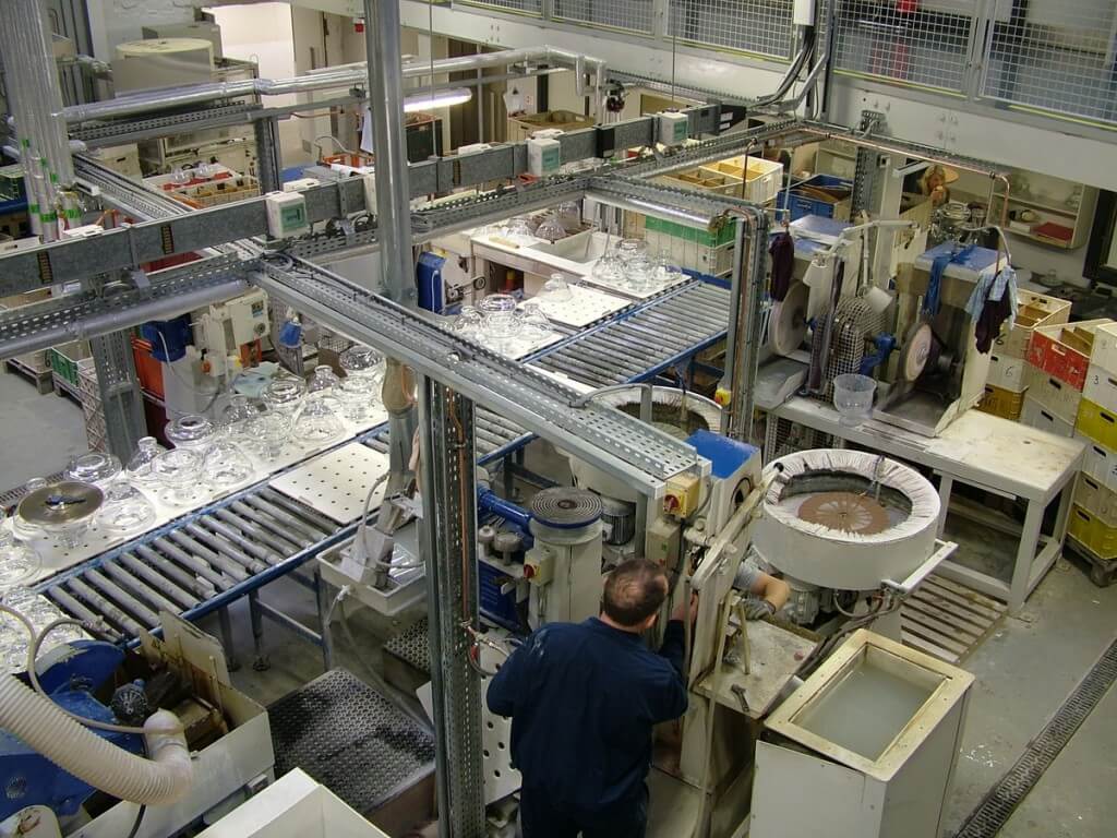 An image of a worker in the quality control room at the Waterford Crystal factory in Waterford, Ireland. Photography by Frame To Frame - Bob and Jean.