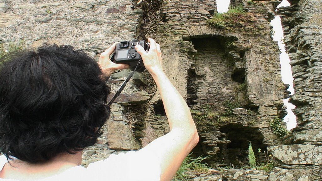 Coppinger's Court ruins, jean takes picture of former fireplace upon wall, county cork, Ireland