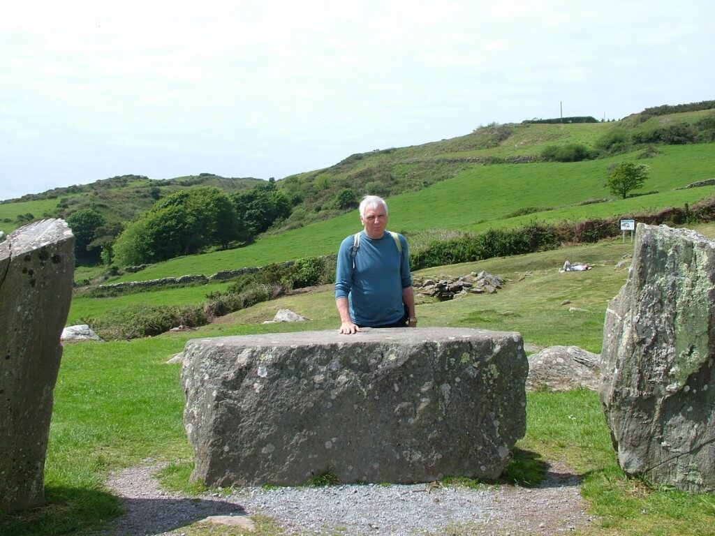 An image of Bob standing beside recumbent axial stone at the Drombeg Stone Circle in County Cork, Ireland. Photography by Frame To Frame - Bob and Jean.