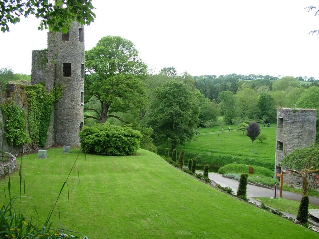 An image of the green lawns and towers beside Blarney Castle, in Ireland. Photography by Frame To Frame - Bob and Jean.