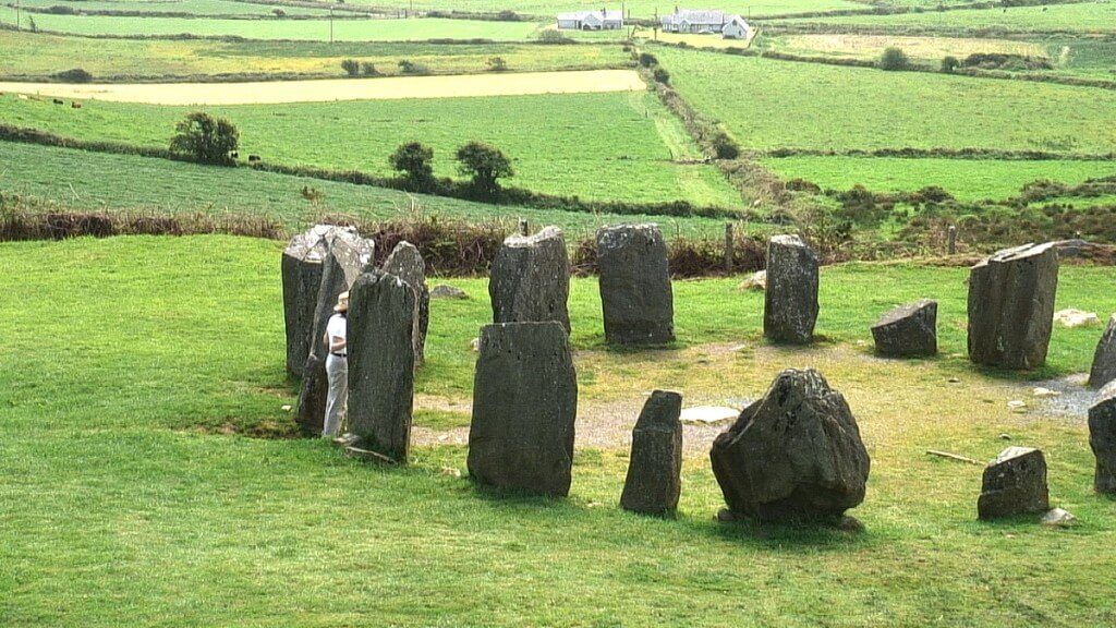 An image of Jean standing among stones at the Drombeg Stone Circle in County Cork, Ireland. Photography by Frame To Frame - Bob and Jean 