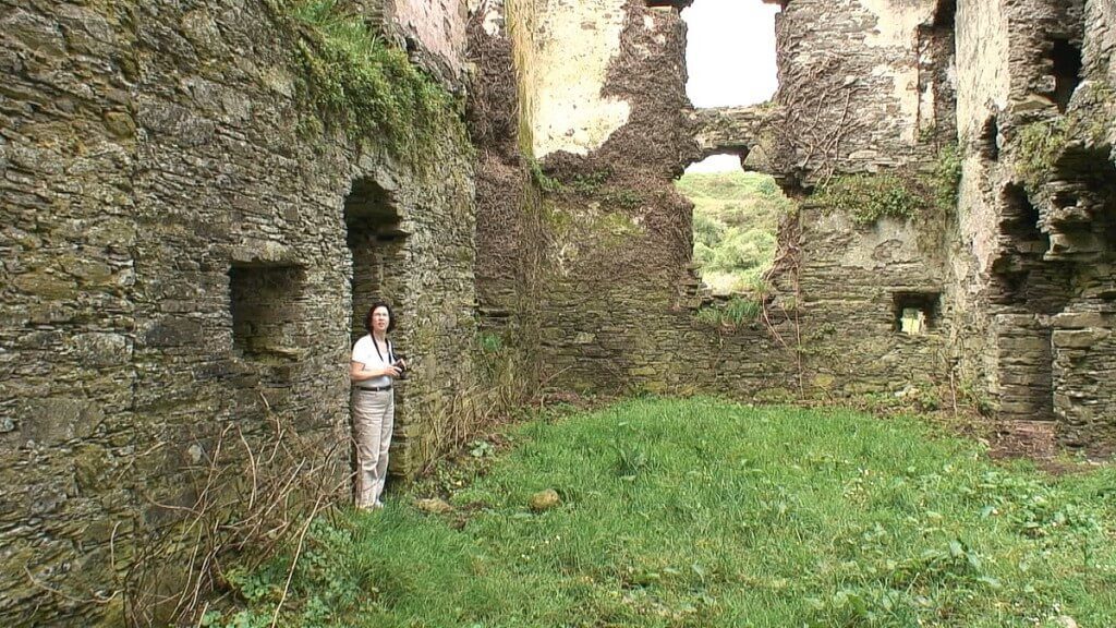 jean stands inside coppingers court ruins, ireland