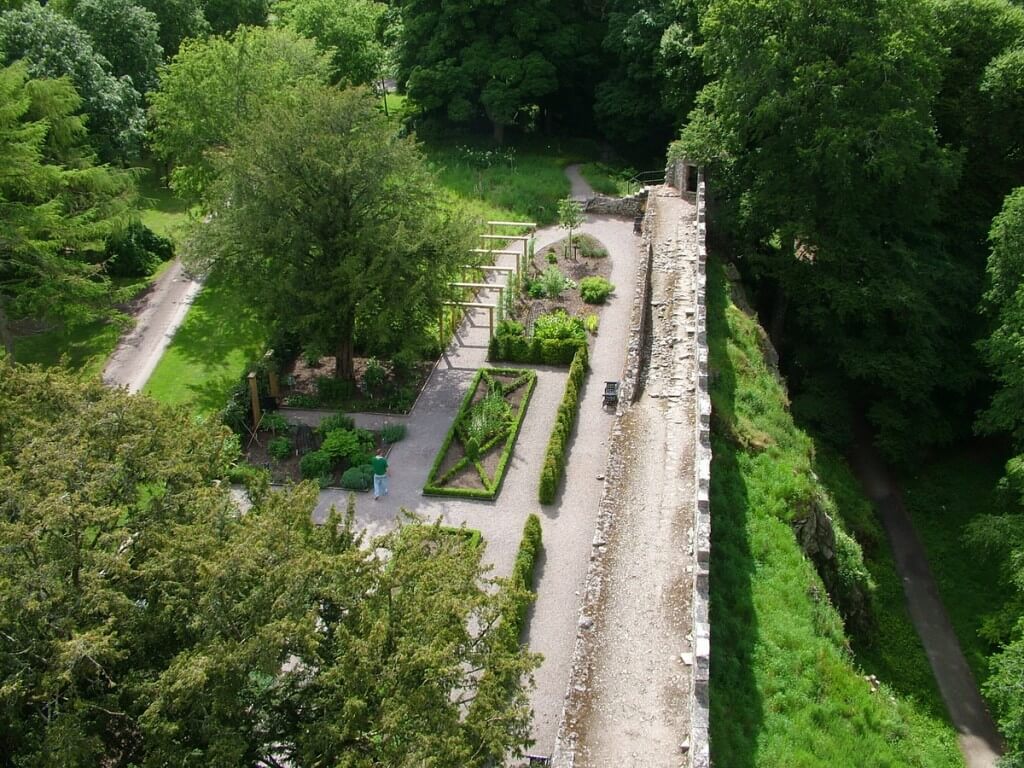 An image of the garden beds in the Poison Garden at Blarney Castle from high above on the castle's battlements in Ireland. Photograph by Frame To Frame - Bob and Jean