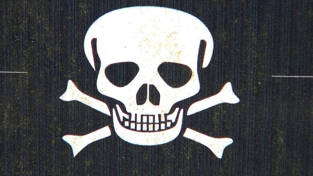 An image of a skull and cross bones symbol sign in the Poison Garden at Blarney Castle in County Cork, Ireland. Photograph by Frame To Frame - Bob and Jean County Cork, Ireland