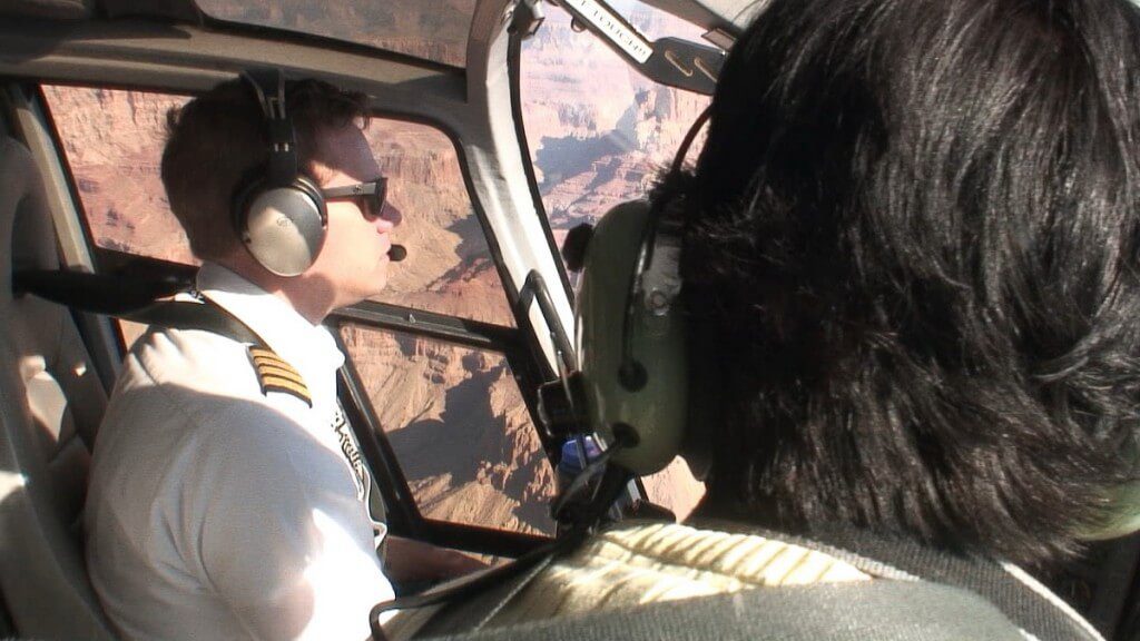 pilot fly helicopter above grand canyon
