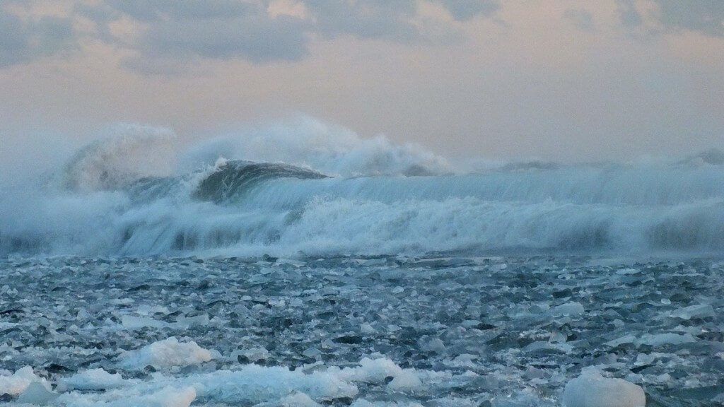 Icy waves breaking at Sunnyside on Lake Ontario in Toronto, Ontario, Canada