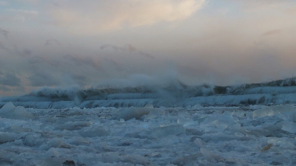 Icy waves breaking at Sunnyside on Lake Ontario in Toronto, Ontario, Canada