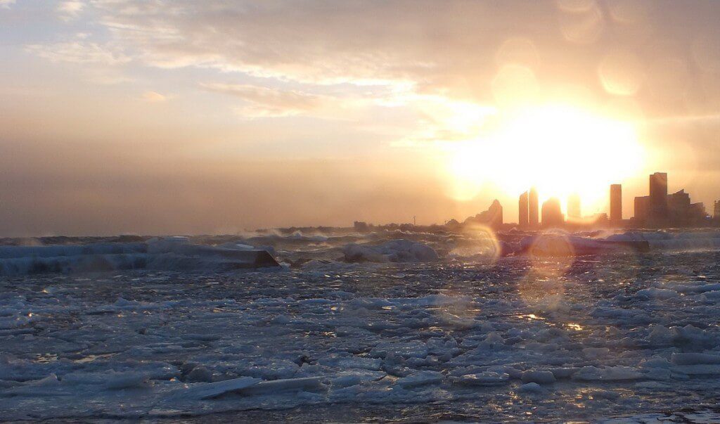 Icy waves breaking as the sunsets at Sunnyside on Lake Ontario in Toronto, Ontario, Canada
