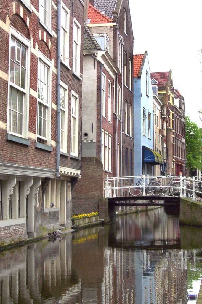buildings and bikes along canal, delft, the netherlands