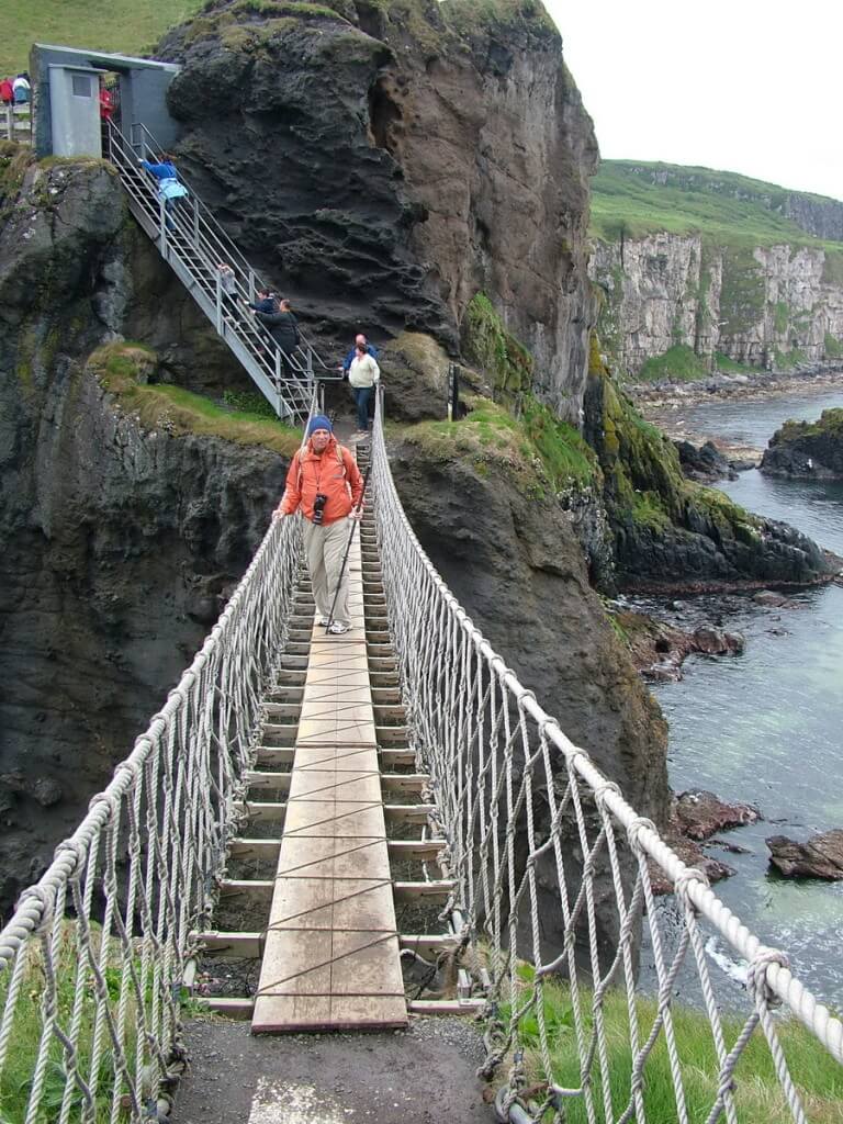 An image of Bob standing on the Carrick-a-Rede rope bridge in Northern Ireland. Photography by Frame To Frame - Bob and Jean.