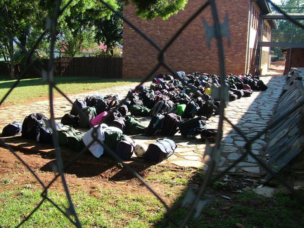 Children's backpacks behind razor wire in Sabie, South Africa