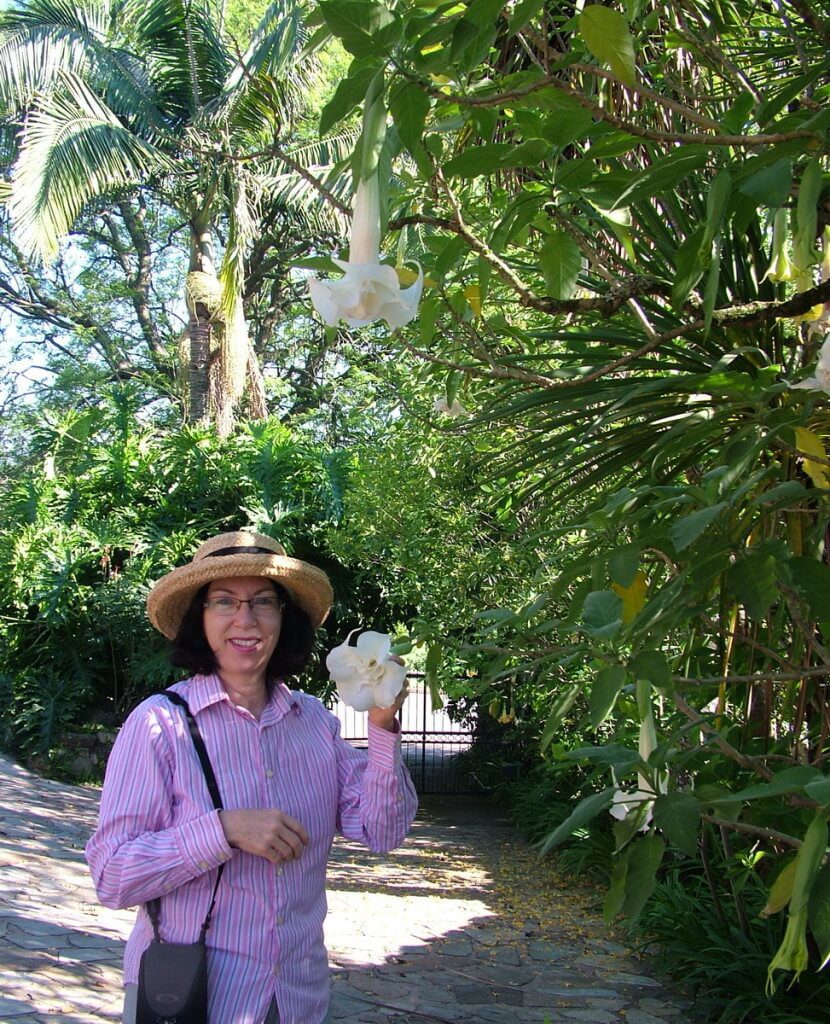 Jean holds a Angel's Trumpet flower at Valley View Lodge in Sabie, South Africa
