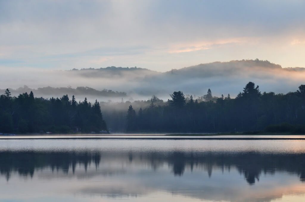 Misty summer morning at Oxtongue Lake, in Ontario, Canada