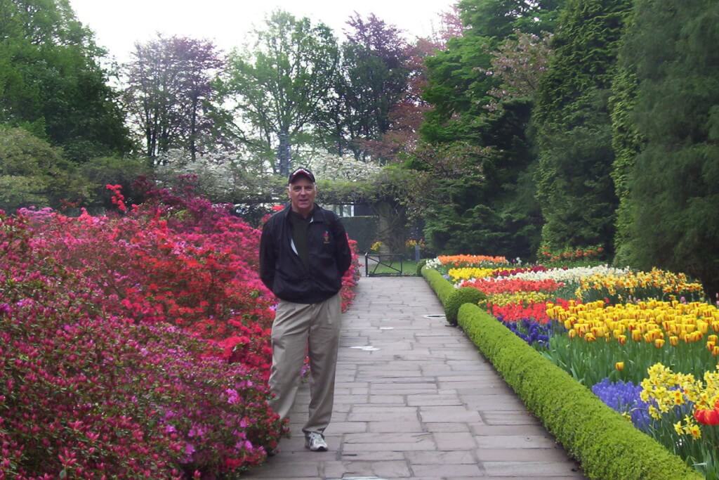 An image of Bob standing beside flower beds at Keukenhof Gardens near Lisse, in the Netherlands. Photography by Frame To Frame - Bob and Jean. 