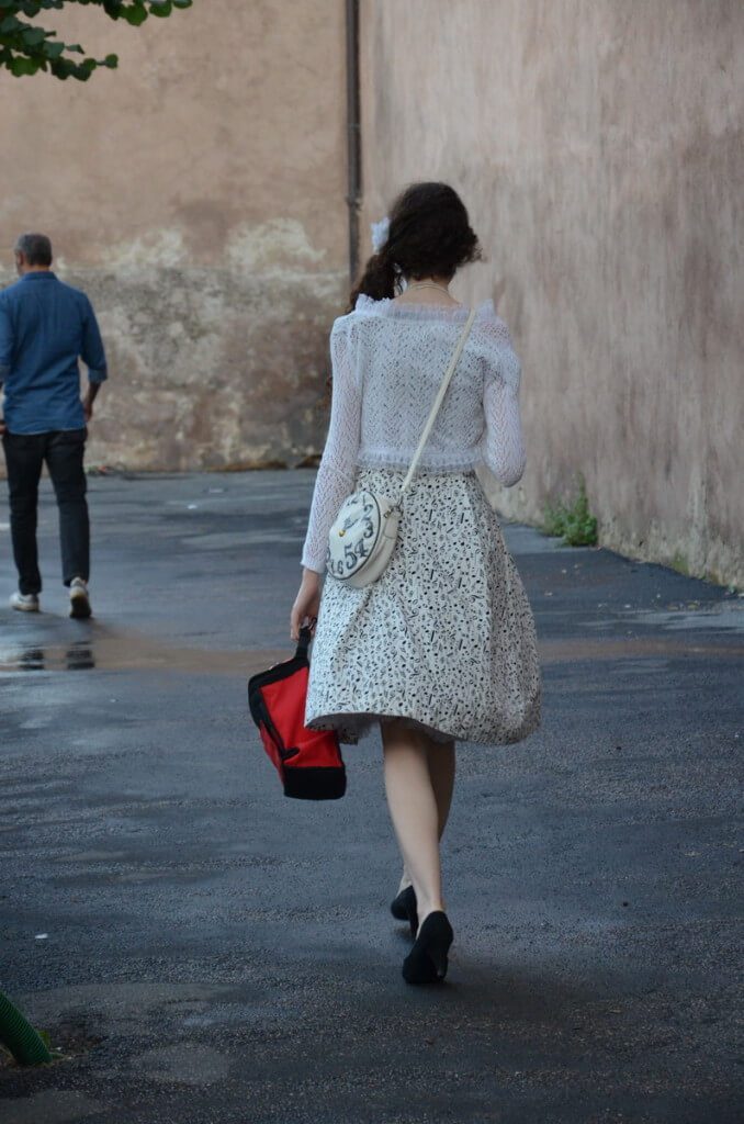Young woman walking in fashionable clothing in Rome, Italy