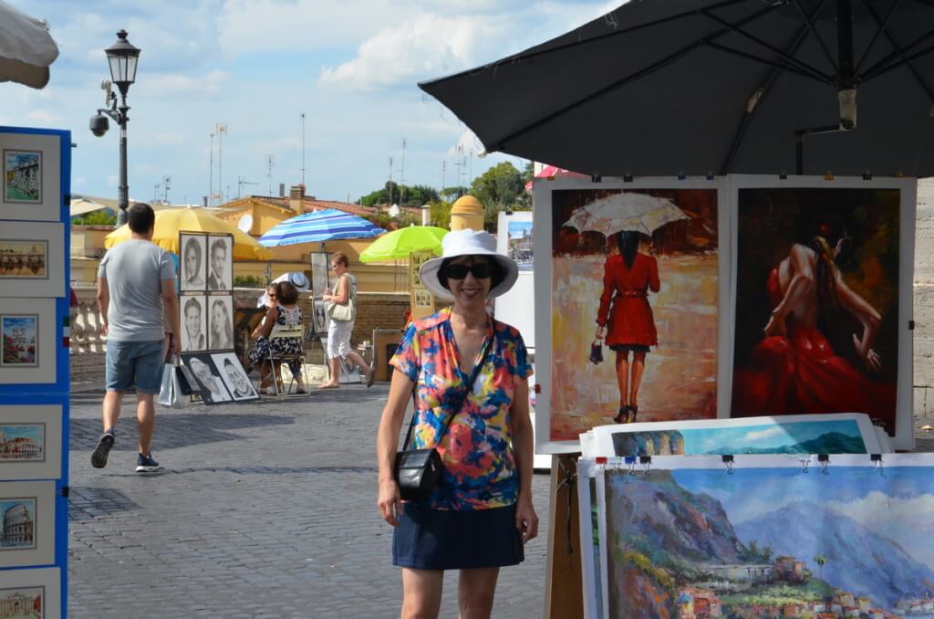 Jean standing beside street art in Rome, Italy