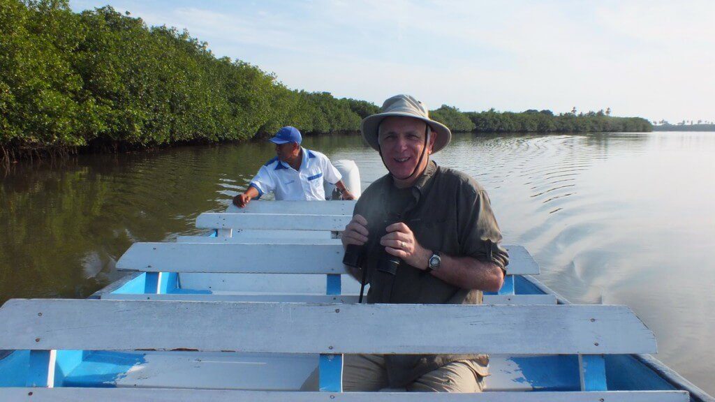 Photo of a boat on the San Cristobal River heading to the mangrove swamp near San Blas, Mexico
