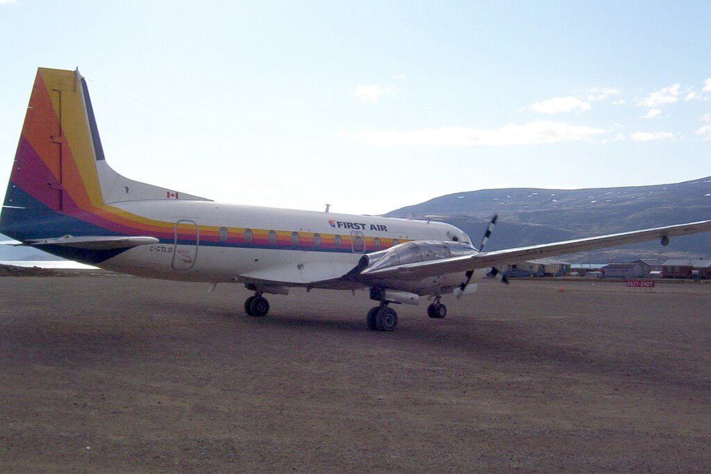 photograph of a First Air prop plane on the dirt runway in Pangnirtung on Baffin Island in Nunavut, Canada