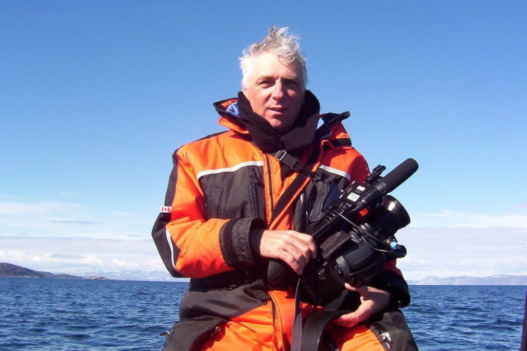 photograph of bob with his film camera off Kekerten Island, Nunavut, Canada