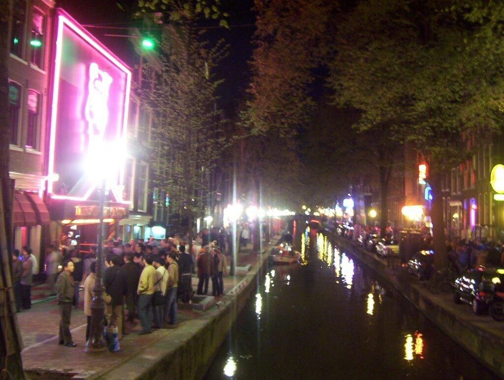 canal life at night in amsterdam