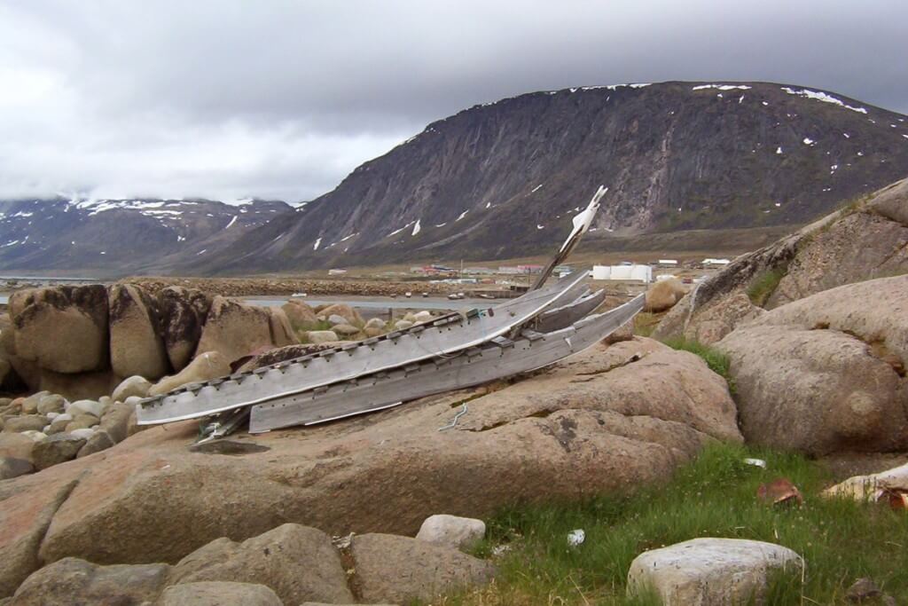 photograph of an inuit toboggan sitting on rocks in Pangnirtung, Nunavut, Canada.